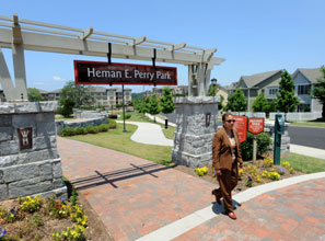 Glover, head of the housing authority, strolls through the redeveloped site of a former project.