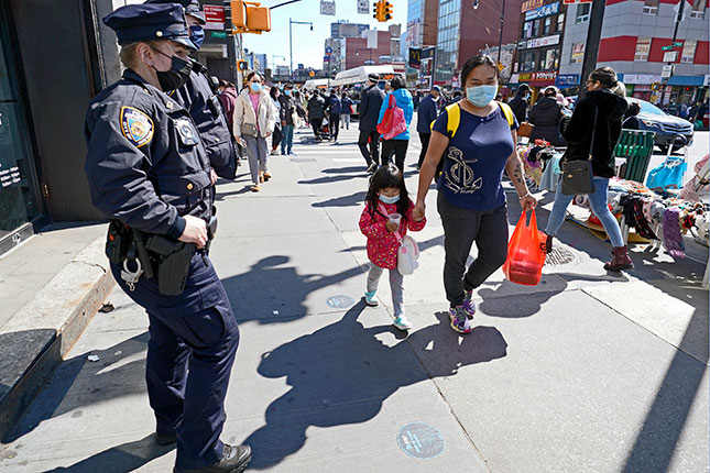 Police patrol a shopping district in Queens, 2021: Wilson argued that “the essence of the police role in maintaining order is to reinforce the informal control mechanisms of the community itself.” (KATHY WILLENS/AP PHOTO)