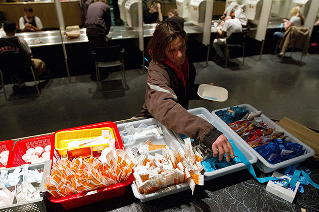 An addict collects her drug kit at a safe-injection center. (LAURENT VU THE/AFP/GETTY IMAGES)